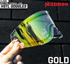Maddog HK Army HSTL Goggle gold anti-fog thermal replacement lens held against dark background