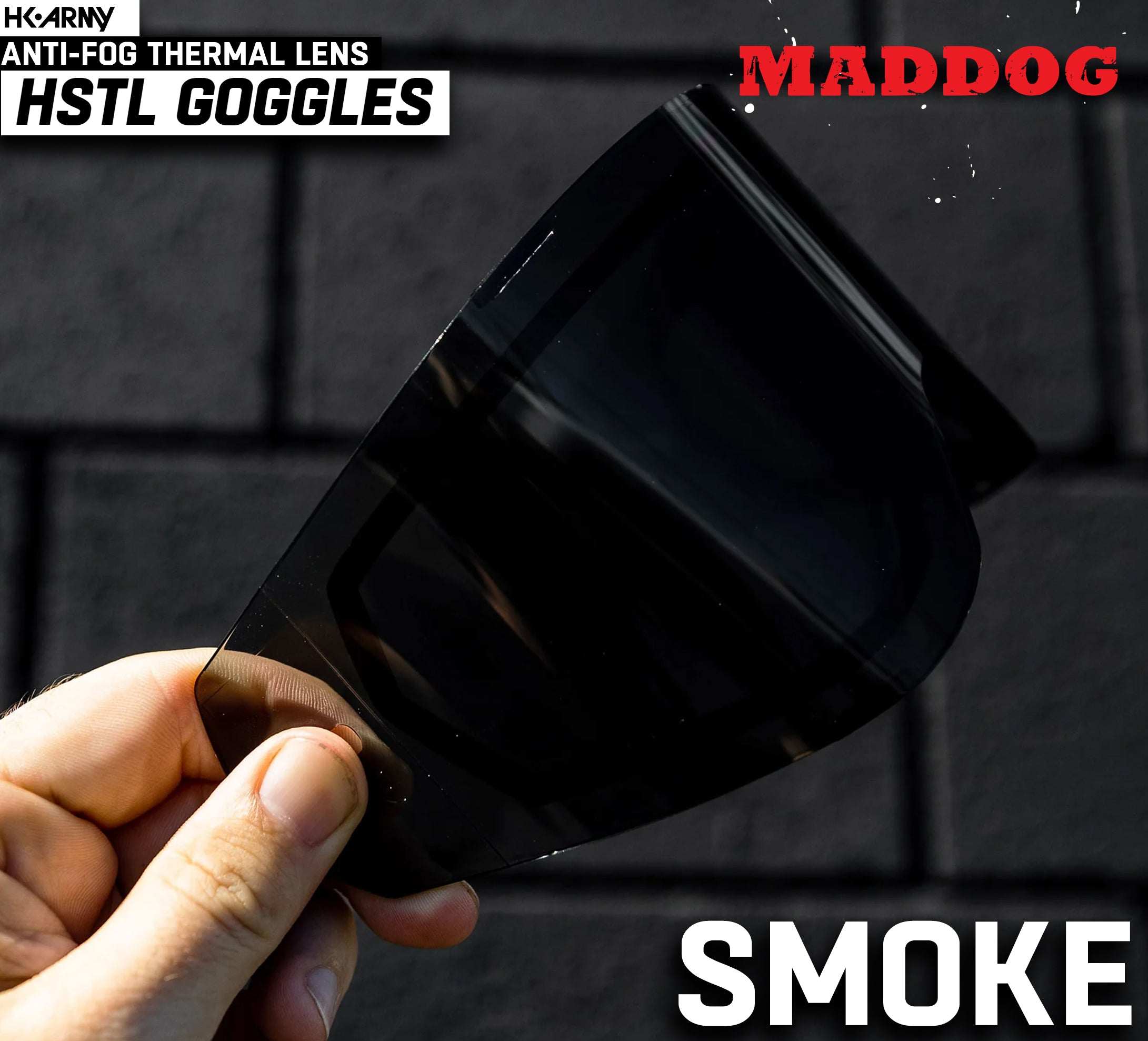 Hand holding a Maddog HK Army HSTL Goggle smoke anti-fog thermal lens for paintball and airsoft protection